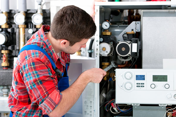 HVAC technician inspecting an indoor heating system in Maricopa, AZ