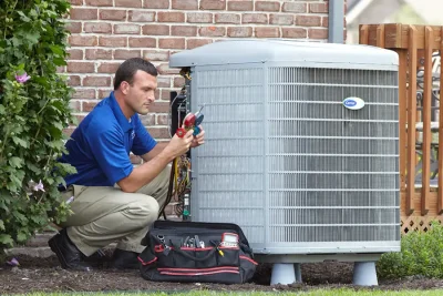 HVAC technician inspecting an outdoor air conditioning unit in Maricopa, AZ